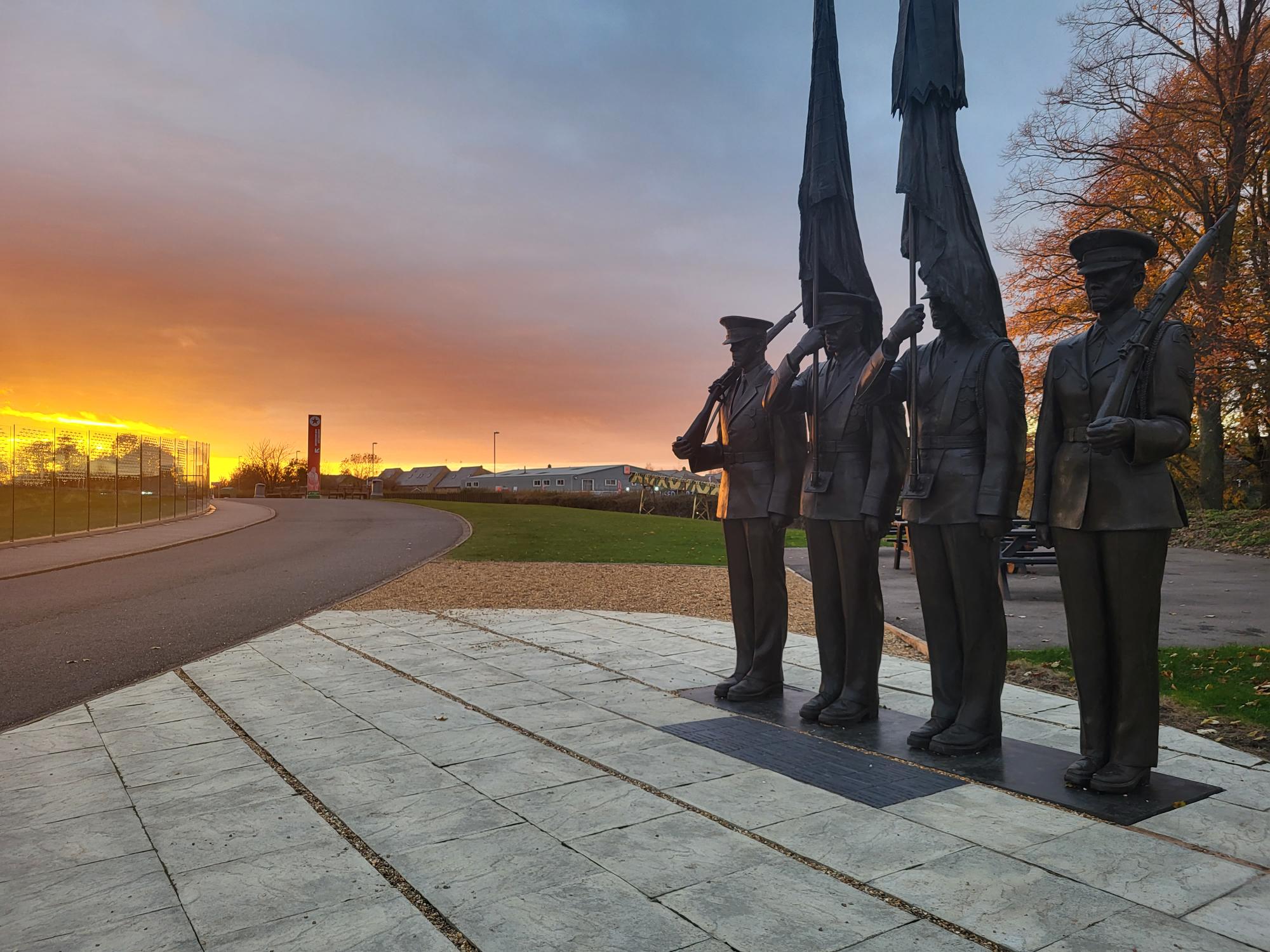 The bricks lay in front of the Honor Guard statue, with the sunrise in the background.
