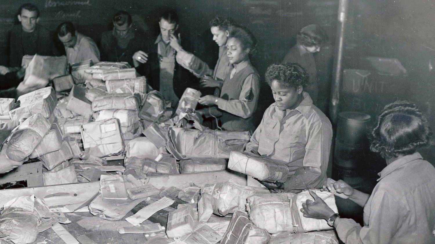 6888th Central Postal Directory Battalion sort packages in Paris in November 1945
