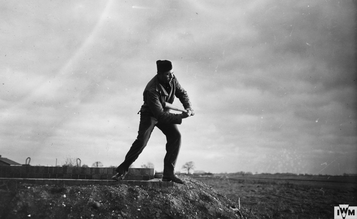 Private First Class Eugene Kiolbassa of the 303rd Bomb Group plays baseball.