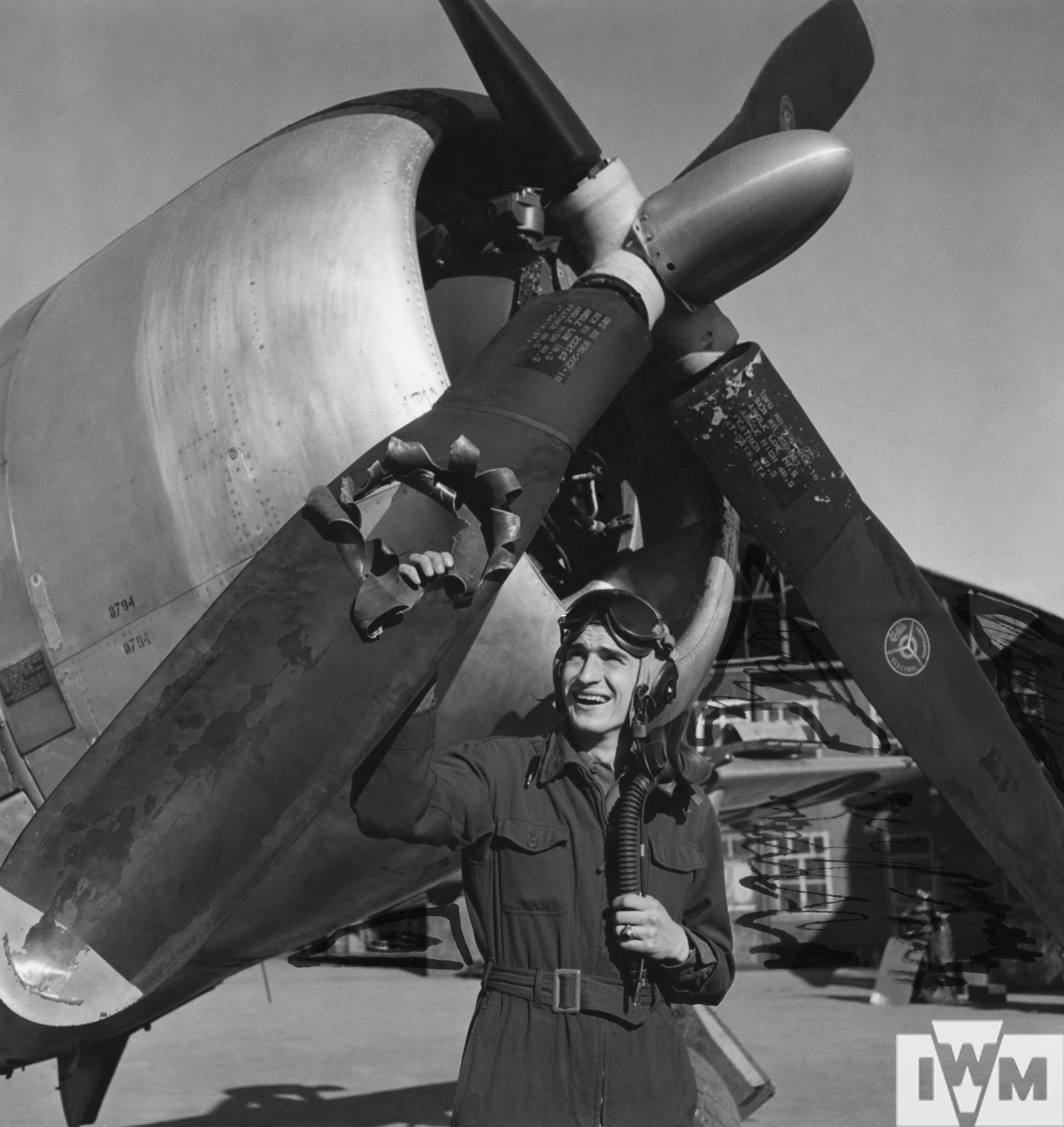 Lieutenant Edwin "Lucky" Wright with the flak damaged engine of his P-47 Thunderbolt, November 1944
