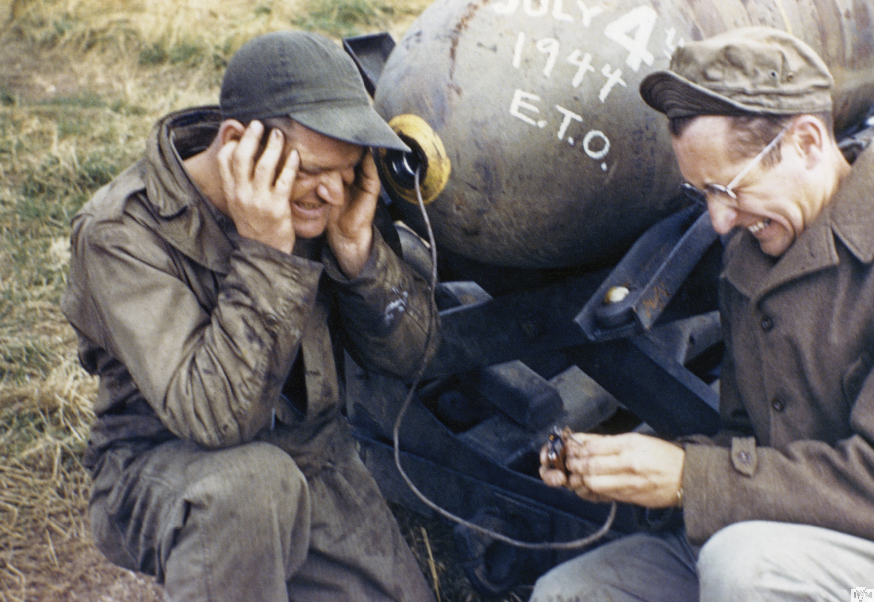 Two airmen of the 55th Fighter Group pretending to detonate a bomb 4 July 1944.