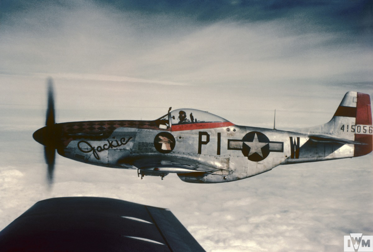 A P-51 Mustang (PI-W, serial number 44-15056) nicknamed "Jackie" of the 356th Fighter Group in flight, flown by Captain Jack W "Wild Bill" Crump. 