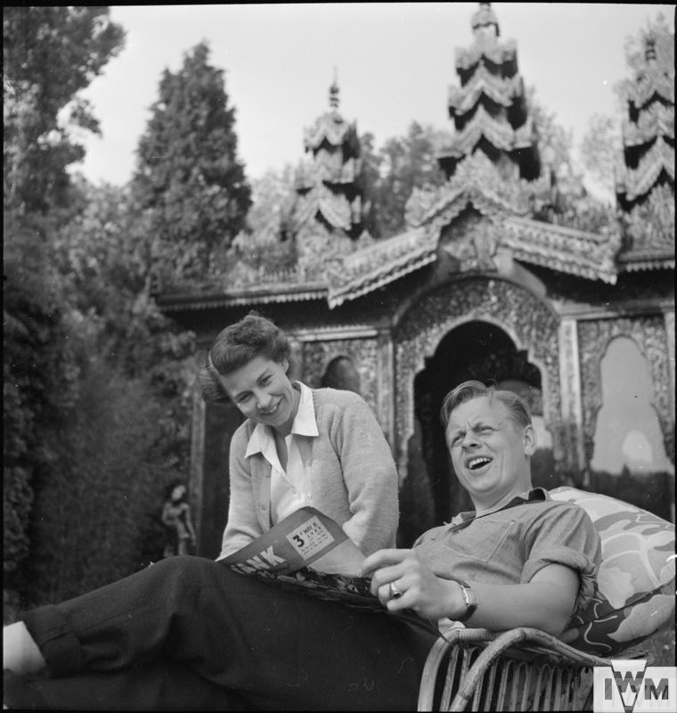 Lieutenant M V Judas from Elgin, Illinois reads a magazine and shares a joke with American Red Cross hostess, Mrs Pam Hanna, whilst relaxing in the sunshine in the grounds of Stanbridge Earls.