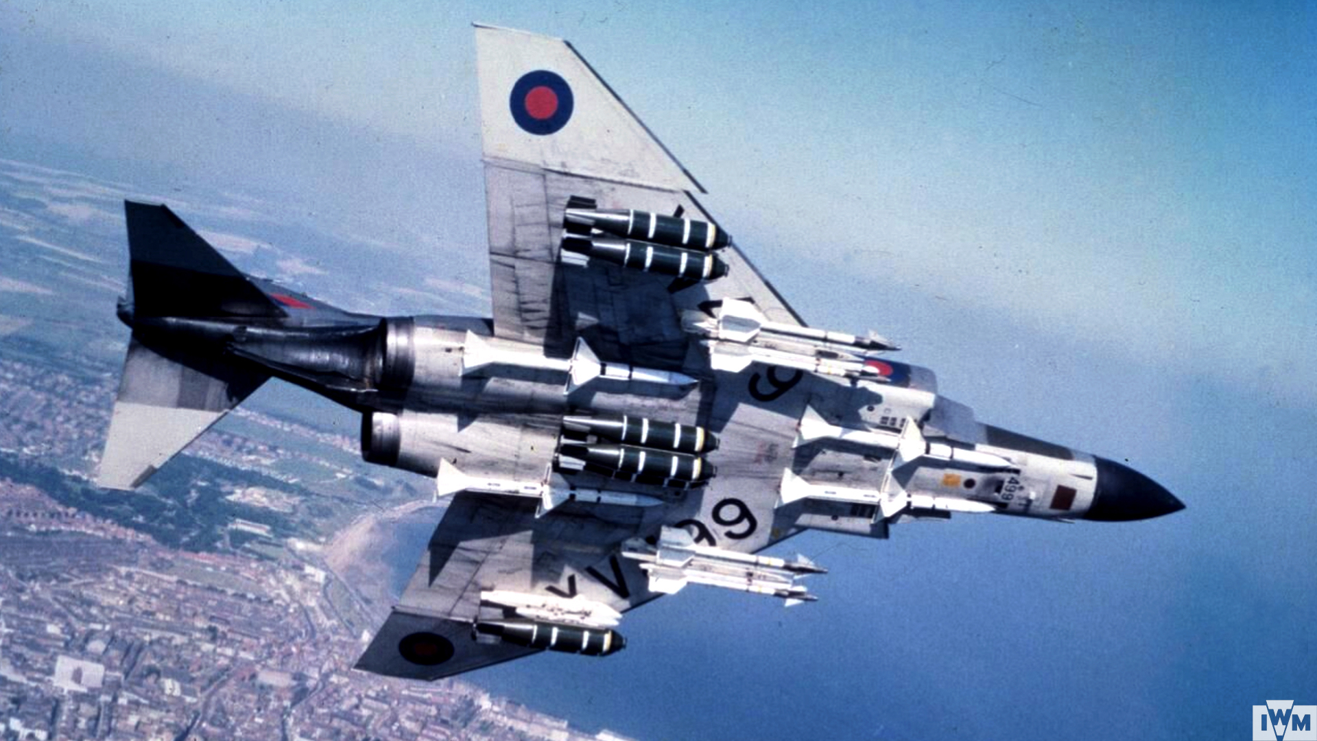McDonnel Douglas Phantom FGR.2, XV499, of No. 41 Squadron based at Coningsby, in flight and displaying a weapons load of cluster bombs, Sparrow and Sidewinder AAMs.