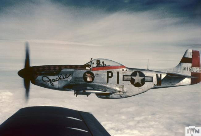 A P-51 Mustang (PI-W, serial number 44-15056) nicknamed "Jackie" of the 356th Fighter Group in flight, flown by Captain Jack W "Wild Bill" Crump. 